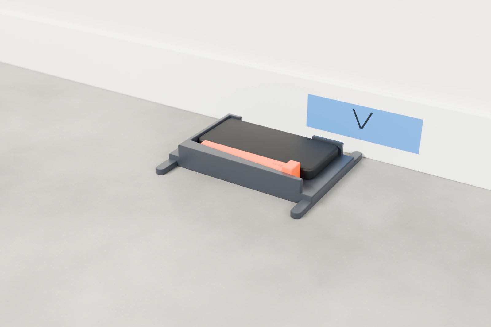 The bracket lying flat on a garage floor with its prongs against the baseboard, below a strip of blue tape marked with a V