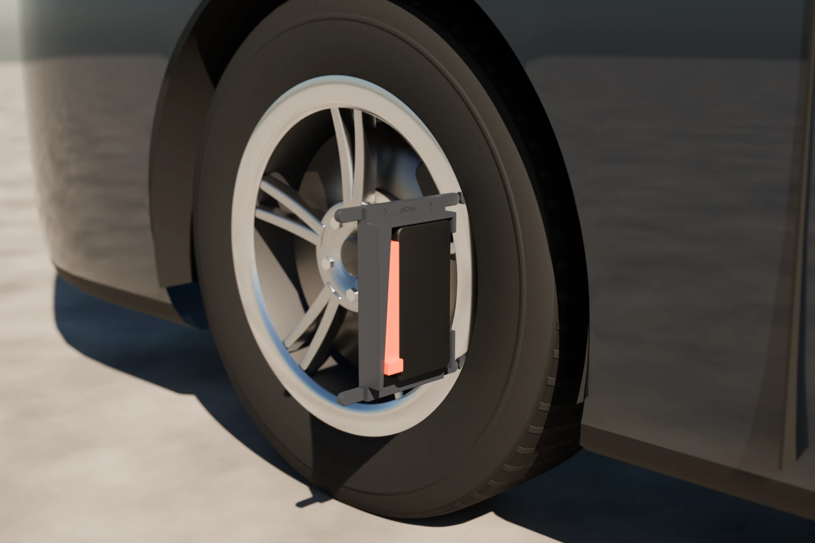 The bracket standing on its edge against the side of a wheel's rim, FRONT pointing up